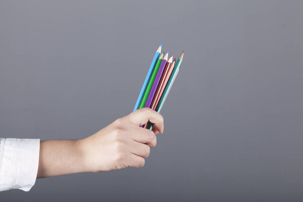 карандаши женского цвета на сером фоне
