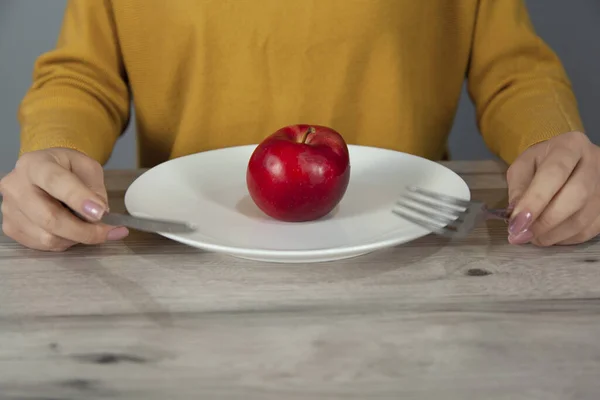 woman  hand  apple on  white plate on  table
