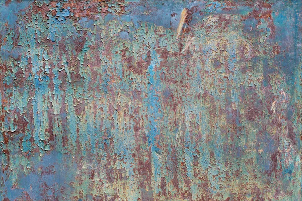 Painted metal with cracks in the paint, roughness, rust. Iron sheet covered with old paint, which has cracked from time and weather conditions. Rusty metal surface. Metal background, texture, backdrop.