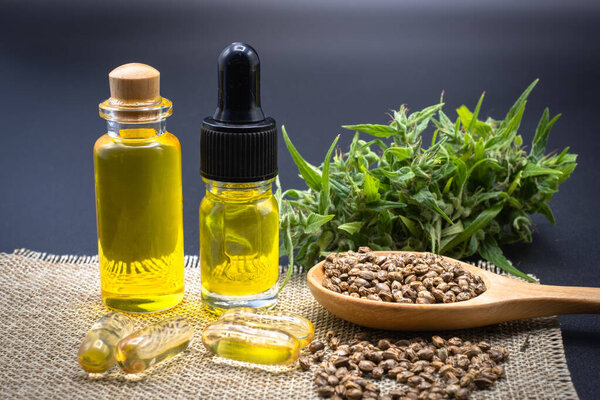 Glass bottles containing CBD hemp oil and drugs extracted from hemp oil of researchers or medical team. Black background. CBD Cannabis Oil, Cannabis Products, Recreation