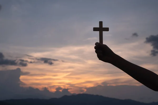 The hand holding the cross.The symbol of the blessing of Jesus.A symbol of pleading and faith.The symbol of the cross with the sunshine in the sky. Have space to enter text.