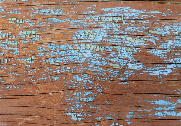 Vecchio sfondo in legno con resti di pezzi di scarti di vecchia vernice su legno. Struttura di un albero vecchio, asse con vernice, vernice di peeling di sfondo d'annata. vecchio bordo blu con vernice incrinata, annata — Foto Stock