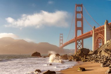 Golden Gate Bridge at sunset seen from San Francisco beach. clipart