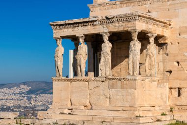 Ancient Erechtheion temple with Caryatid Porch on the Acropolis near Parthenon, Athens, Greece.