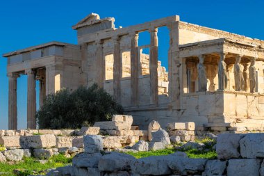 Ancient Erechtheion temple with Caryatid Porch on the Acropolis near Parthenon, Athens, Greece.