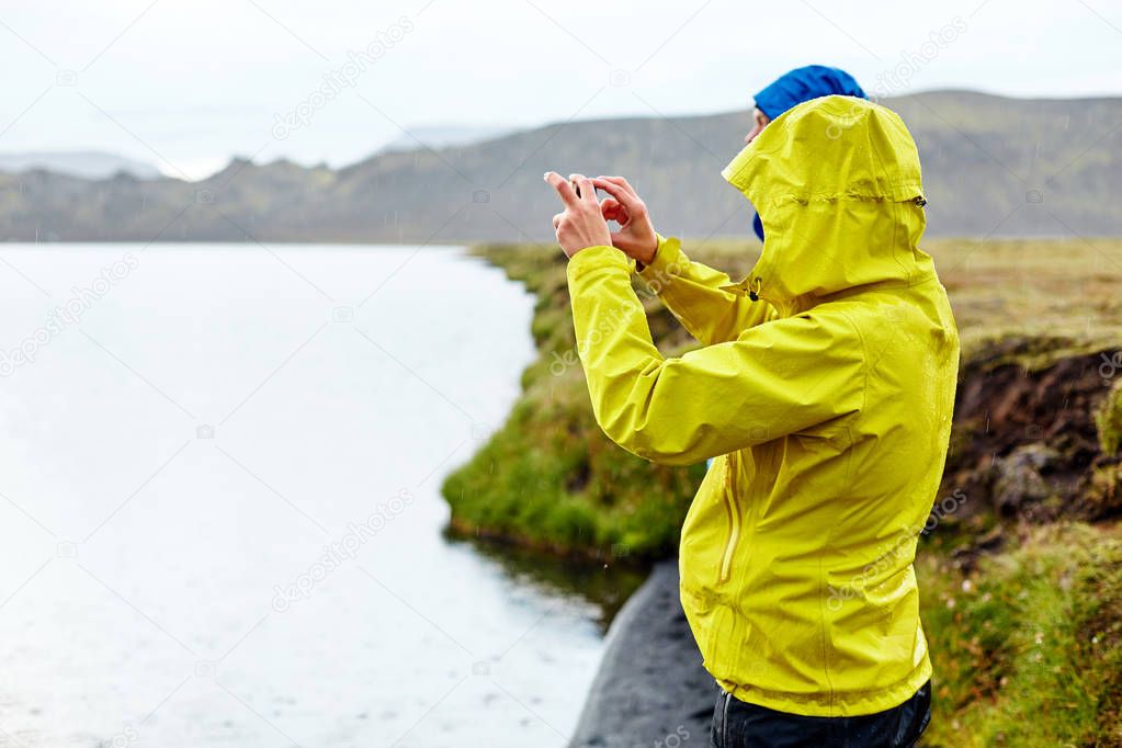 hikers on the Lake coast with mountain reflection, Iceland