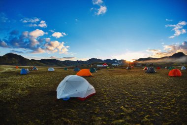 trekking in Iceland. camping with tents near mountain lake clipart