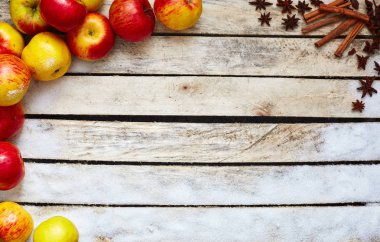 Beyaz ahşap masa, kırmızı ve sarı elmalar