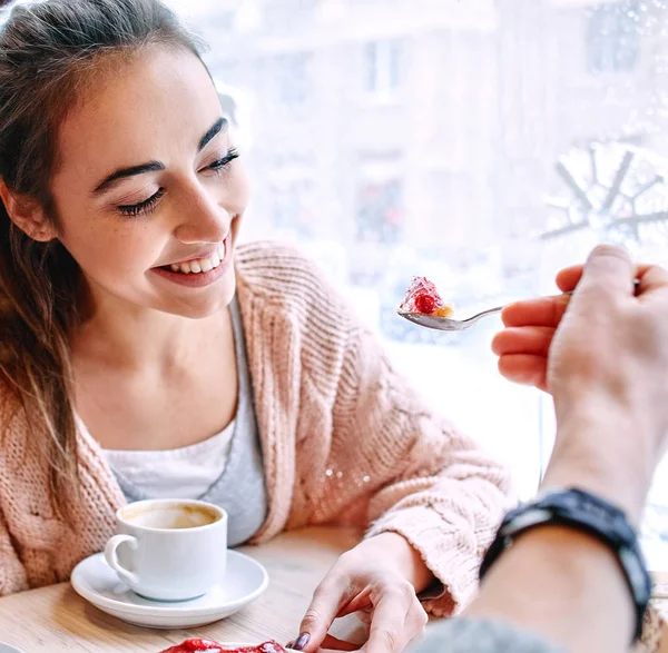Couple eating a dessert spoon in cafe on date — Stock Photo, Image