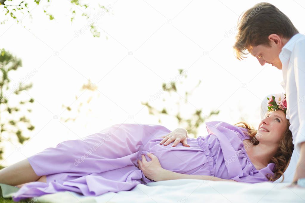 Pregnant woman lying on her back and smiling