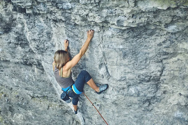 女性ロック ・ クライマーが崖の上に登る — ストック写真