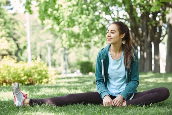 Portrait of young and sporty woman in sportswear doing yoga or Stretching exercises — Stock Photo, Image