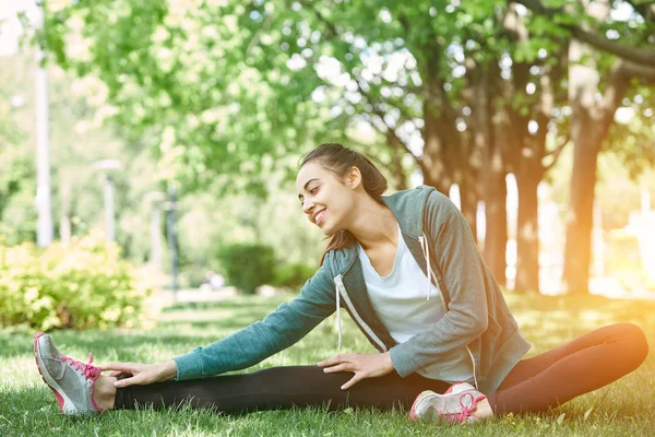 Portrait of young and sporty woman in sportswear doing yoga or Stretching exercises — Stock Photo, Image