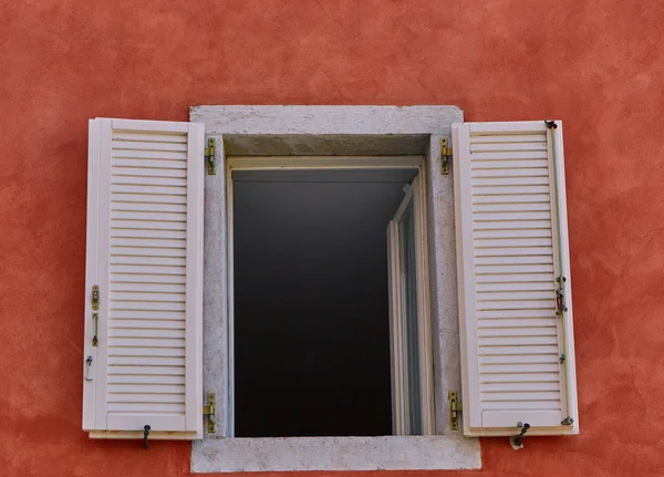 Open white window on the Red Wall