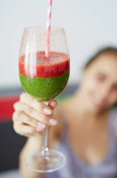 Smiling woman with glass of strawberry smoothies with a green cocktail — Stock Photo, Image