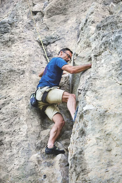Uomo arrampicatore sulla scogliera — Foto Stock