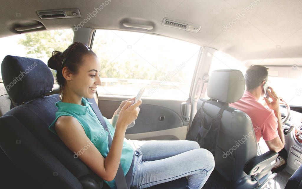 People with phones in the car