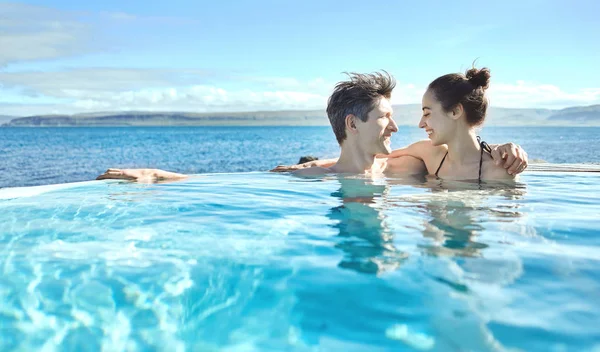 女性と男性は、外のプールでリラックス — ストック写真