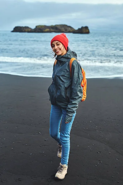 Femme marchant sur Kirkjufjara plage de sable noir, sud de l'Islande . — Photo
