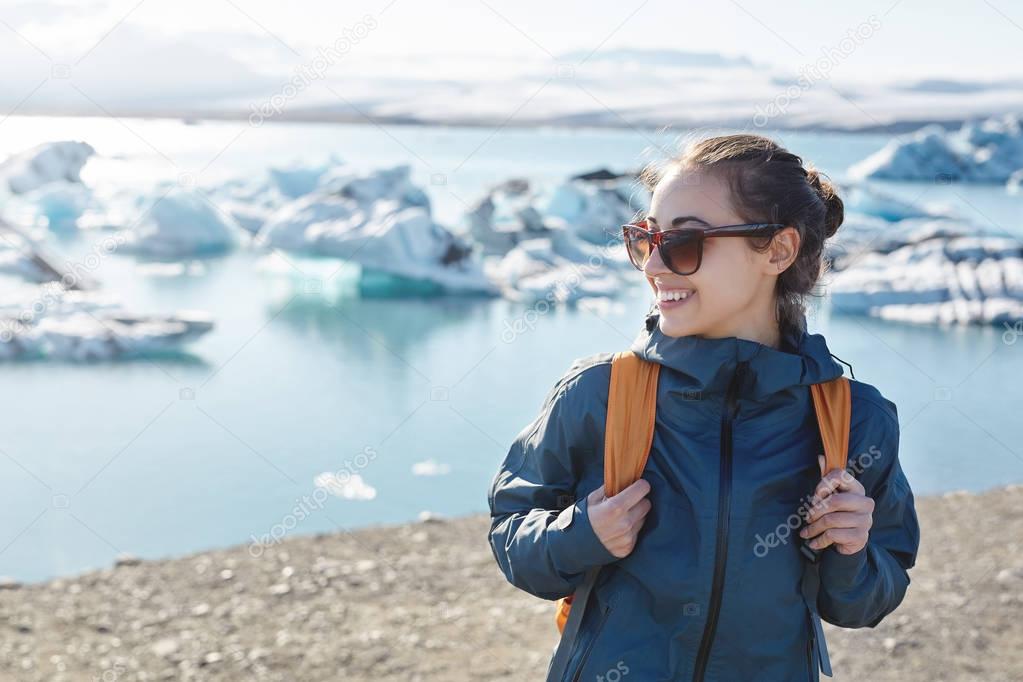 Woman with backpack in Ice Lagoon in Iceland