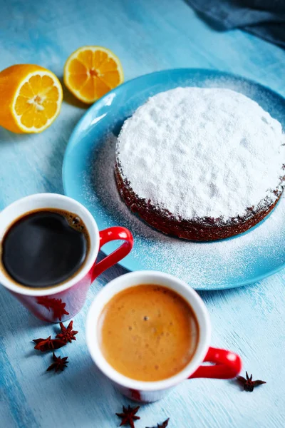 Whole biscuit sprinkled with powdered sugar on the blue plate — Stock Photo, Image
