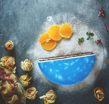 bir koyu gri beton zemin üzerine mavi sır ile kesilerek mousse kek yarısı