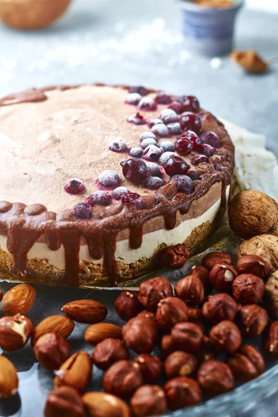 Chocolate vegan cake with different nuts, dates and carob