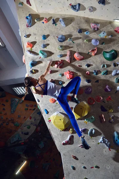 woman climber climbs indoors