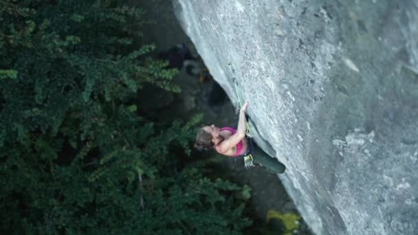 Vista superior mulher alpinista escalada na rota do esporte difícil, olhando, procurando, atingindo e agarrando detém — Vídeo de Stock