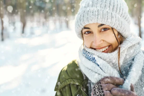 Ritratto ravvicinato di divertente donna sorridente in cappello di lana e lunga sciarpa calda al parco invernale innevato — Foto Stock