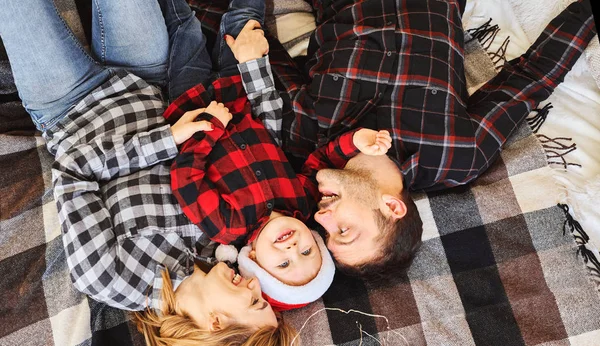 Christmas family spending time together at home, lying on the bed at home.