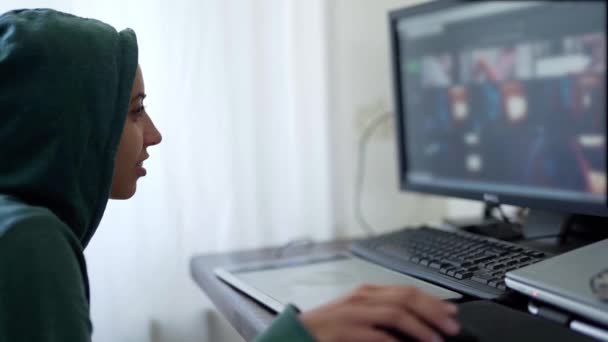 Πλευρά προβολή γυναίκα προγραμματιστής ελεύθερος επαγγελματίας χάκερ με κουκούλα που εργάζονται με τη χρήση υπολογιστή — Αρχείο Βίντεο