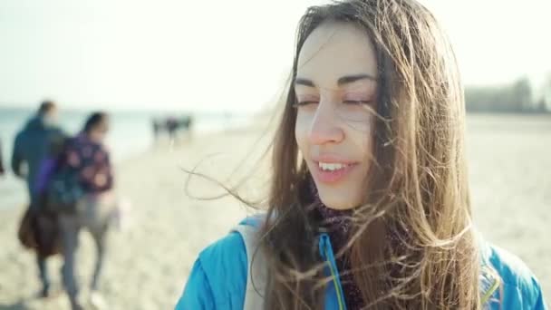 Close up portrait of attractive smiling young brunette woman outdoors — Stock Video