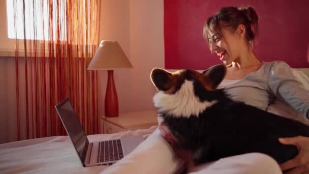 Gelukkig vrouw liggend op bed thuis en chatten met vriendje, met video bellen op laptop computer, met behulp van draadloos speed internet. — Stockvideo