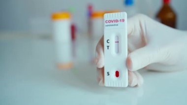 COVID-19 analizi için eldiven tutan yakın plan bilim adamı.