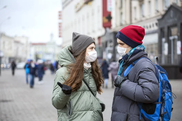 Young Girl and Young Guy on City Street in Protective Masks on His Face. Concept -  Prevent Virus Infection. Europe. City Life. Casual. Close up. Selective Focus.