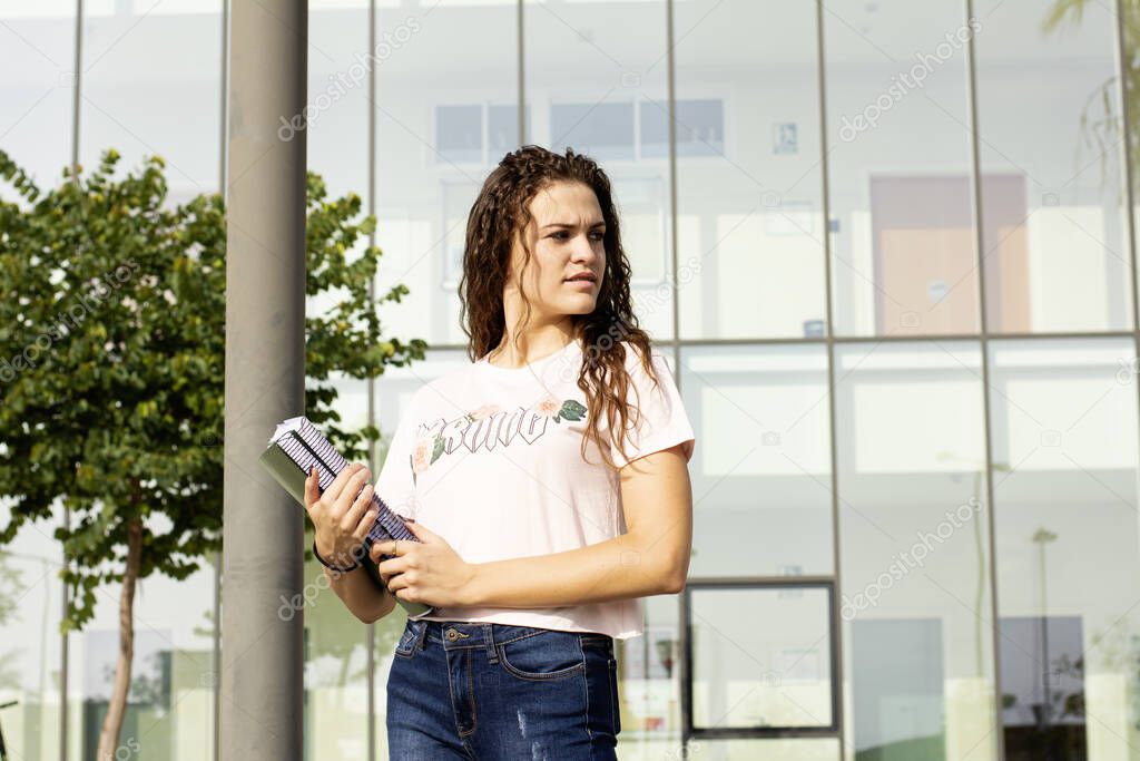 Teen student girl with books in high school or college