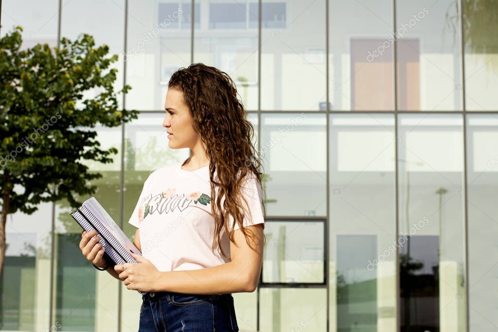 Teen student girl with books in high school or college