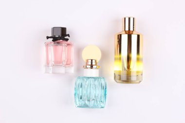 set of aroma perfumes with rose flowers on white background