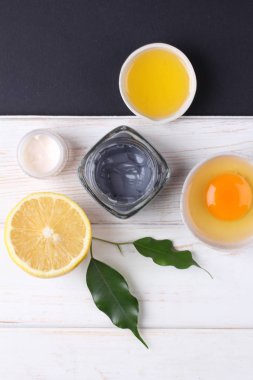 top view on organic cosmetics set with creams, lemon slice and egg yolk