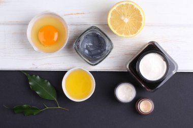top view on organic cosmetics set with creams, lemon slice and egg yolk