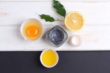 top view on organic cosmetics set with creams, lemon slice and egg yolk