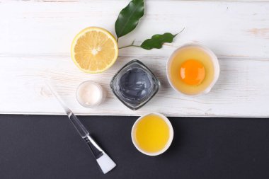 top view on organic cosmetics set with creams, lemon slice and egg yolk