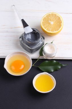 top view on organic cosmetics set with creams, lemon slice and egg yolk