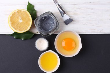 top view on organic cosmetics set with creams, lemon slice and egg yolk