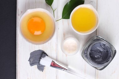 top view on organic cosmetics set with creams, lemon slice and egg yolk