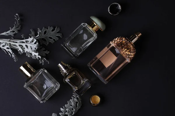 beautiful aroma perfumes set on dark background 