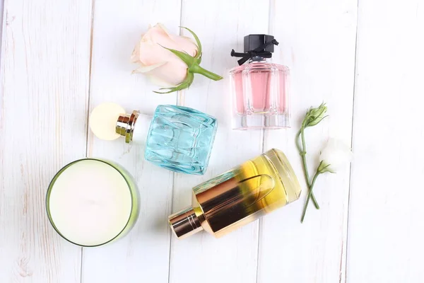 set of aroma perfumes with rose flowers on white background