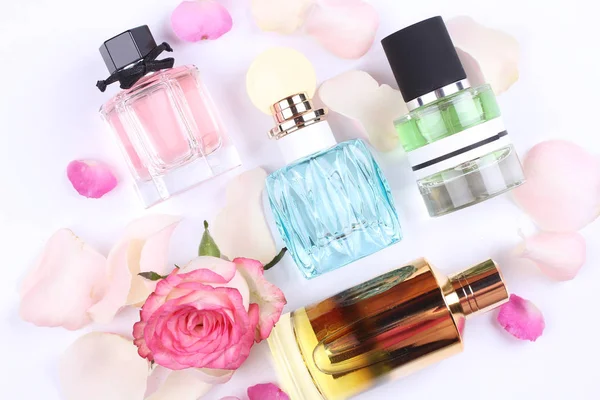 set of aroma perfumes with rose flowers on white background