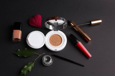 closeup view, cosmetics, makeup and beauty concept on dark background 